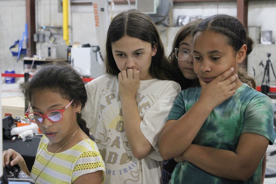 Girls controlling robot